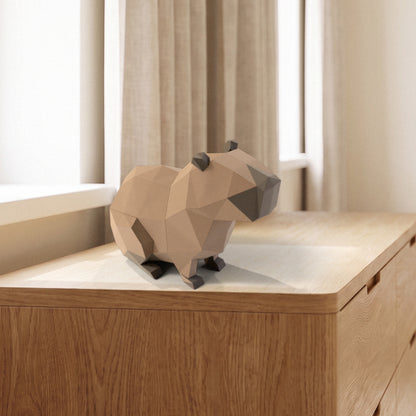 Paper Capybara model on a dresser by the window