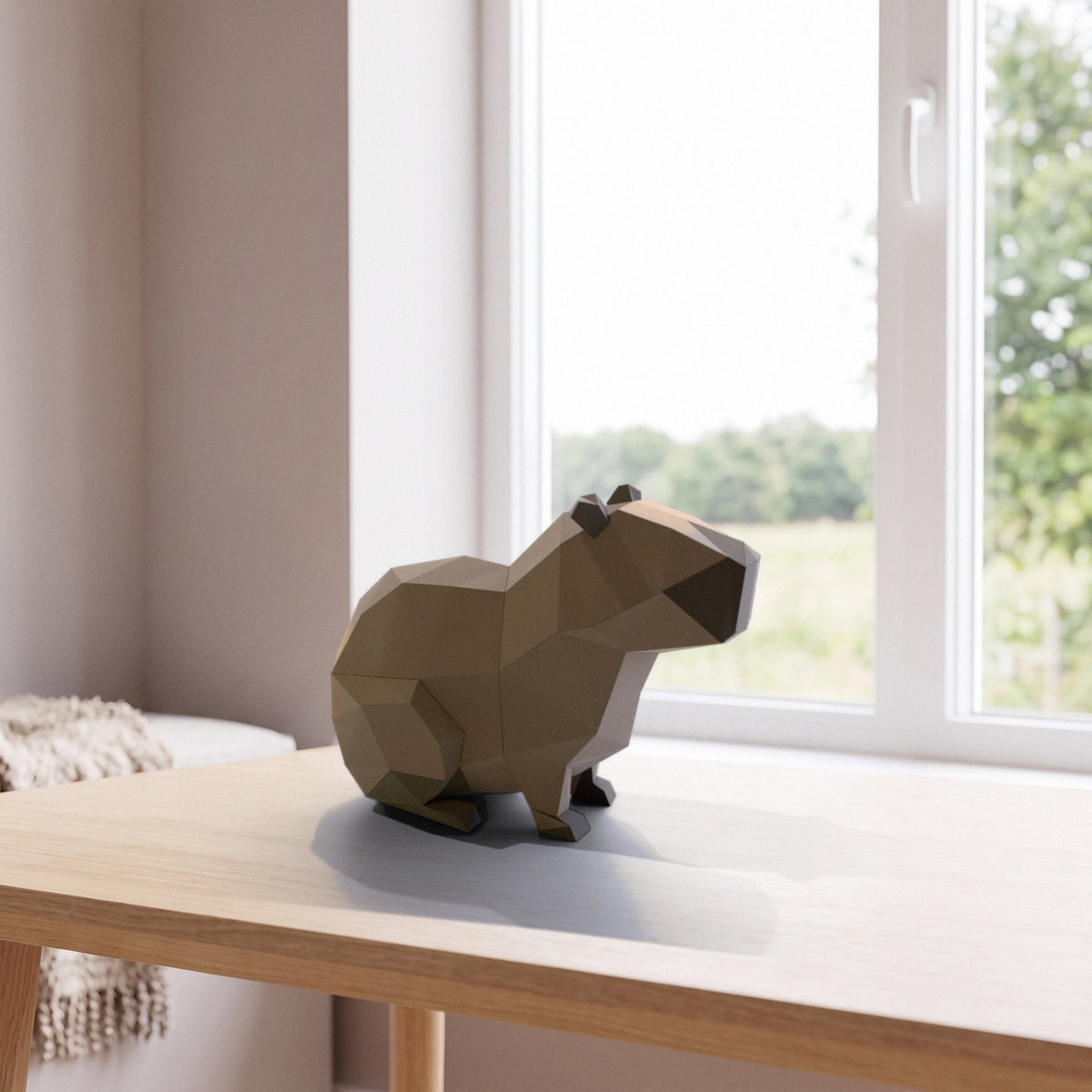 Paper Capybara model on a table by the window
