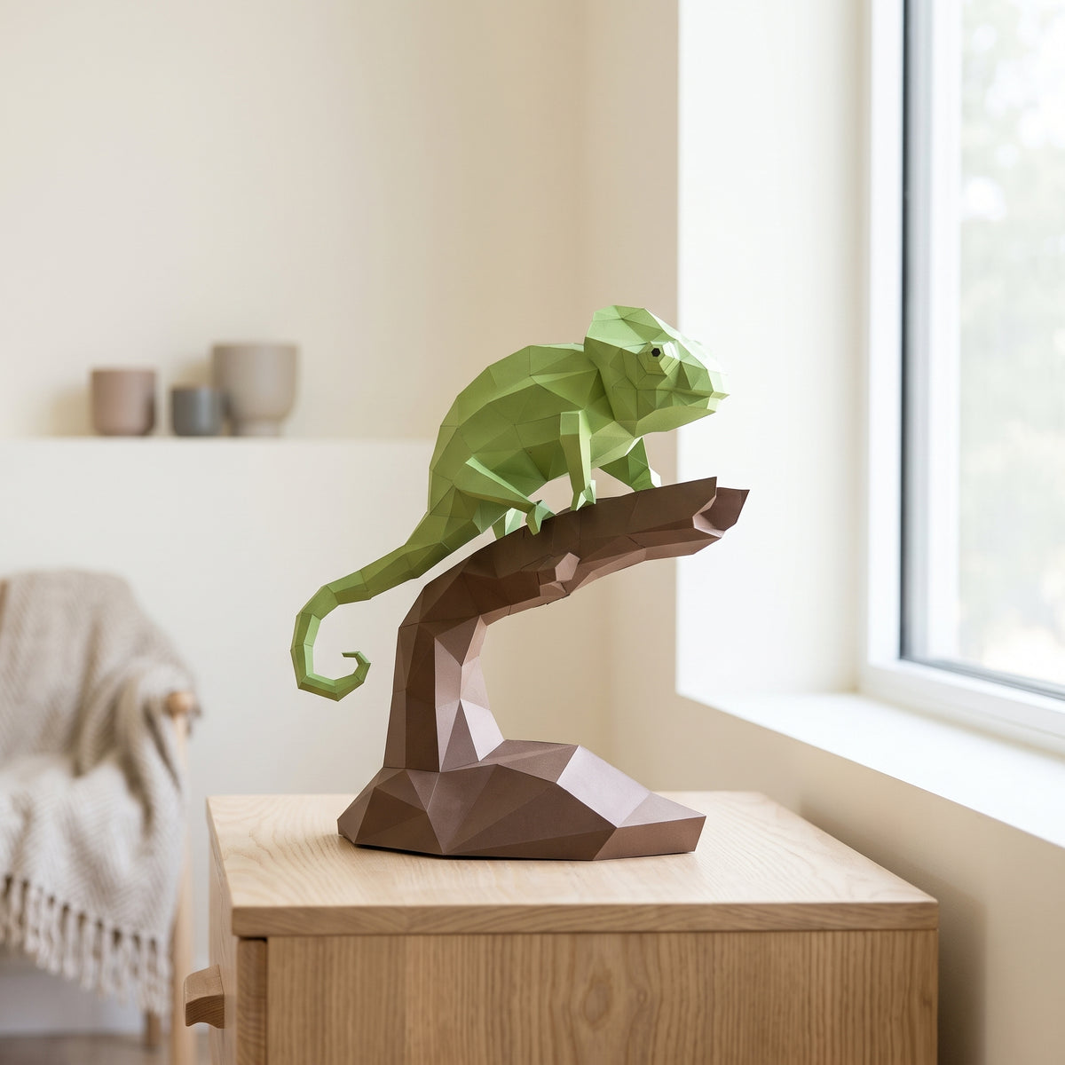Paper Chameleon model on a table by the window