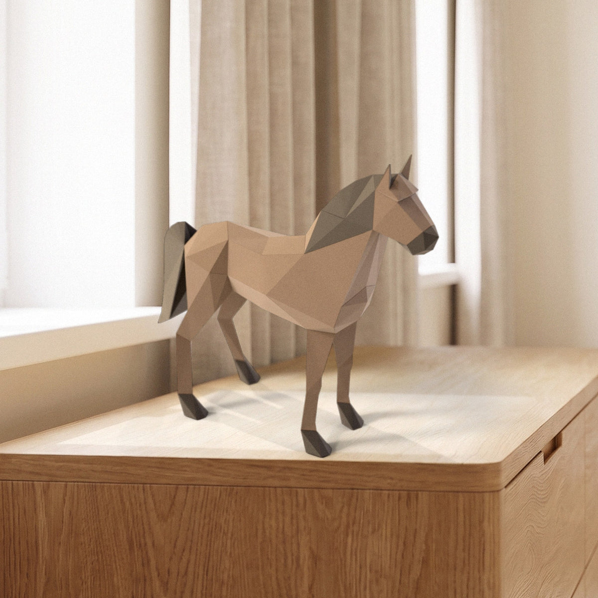 Paper Horse model on a dresser by the window