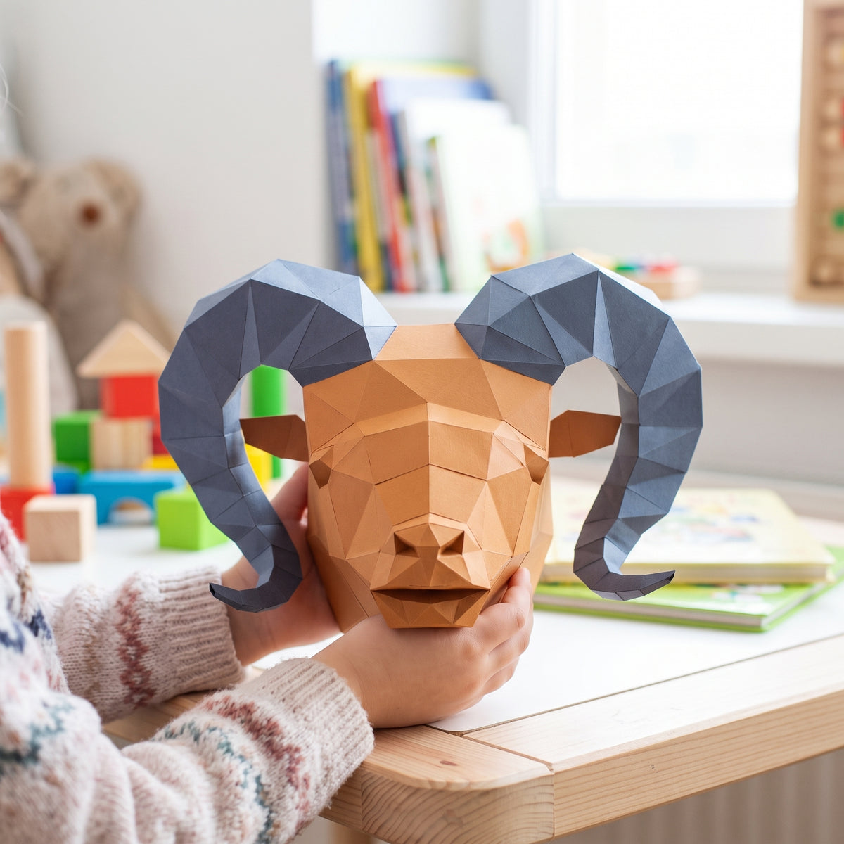 Paper Ram Head model in a child's hands