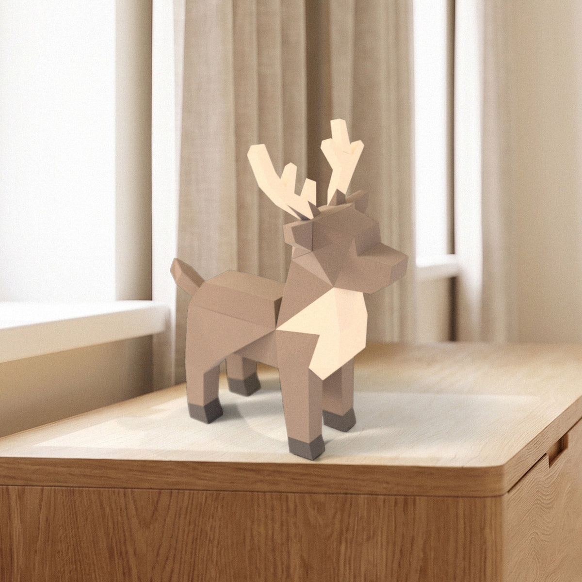 Paper Reindeer model on a dresser by the window