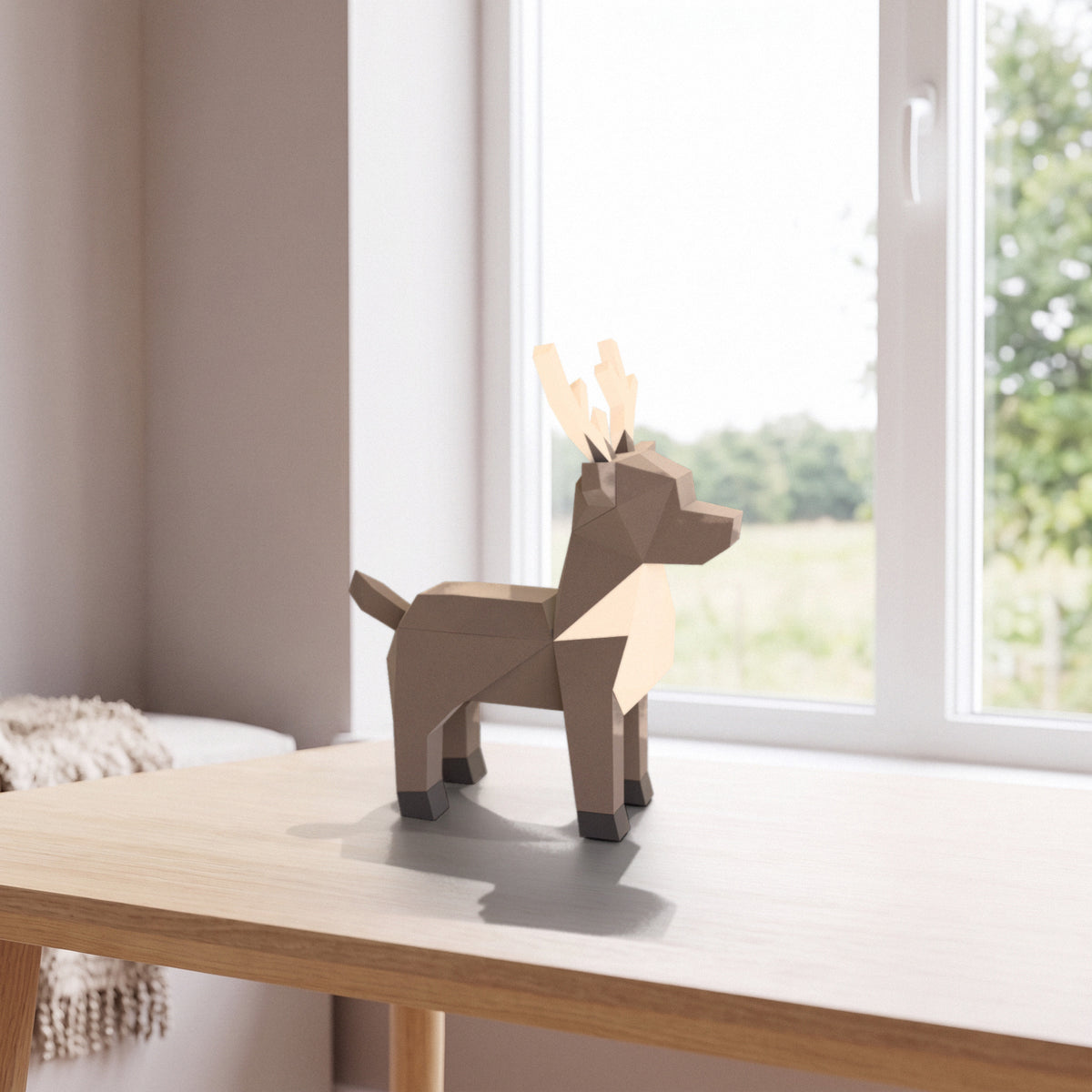 Paper Reindeer model on a table by the window