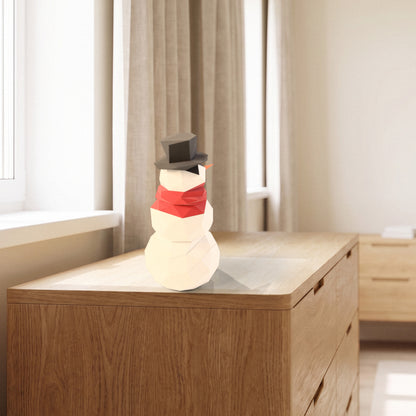 Paper Snowman model on a dresser by the window