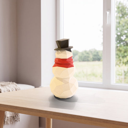 Paper Snowman model on a table by the window