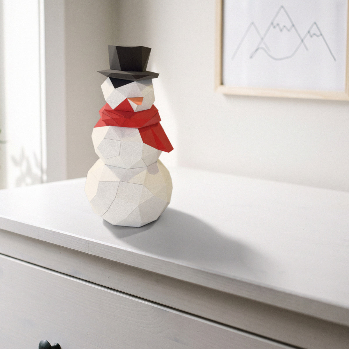 Paper Snowman model on a dresser in a kids' room